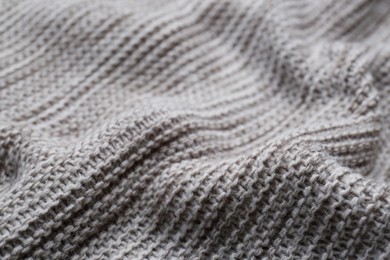 Beautiful grey knitted fabric as background, closeup