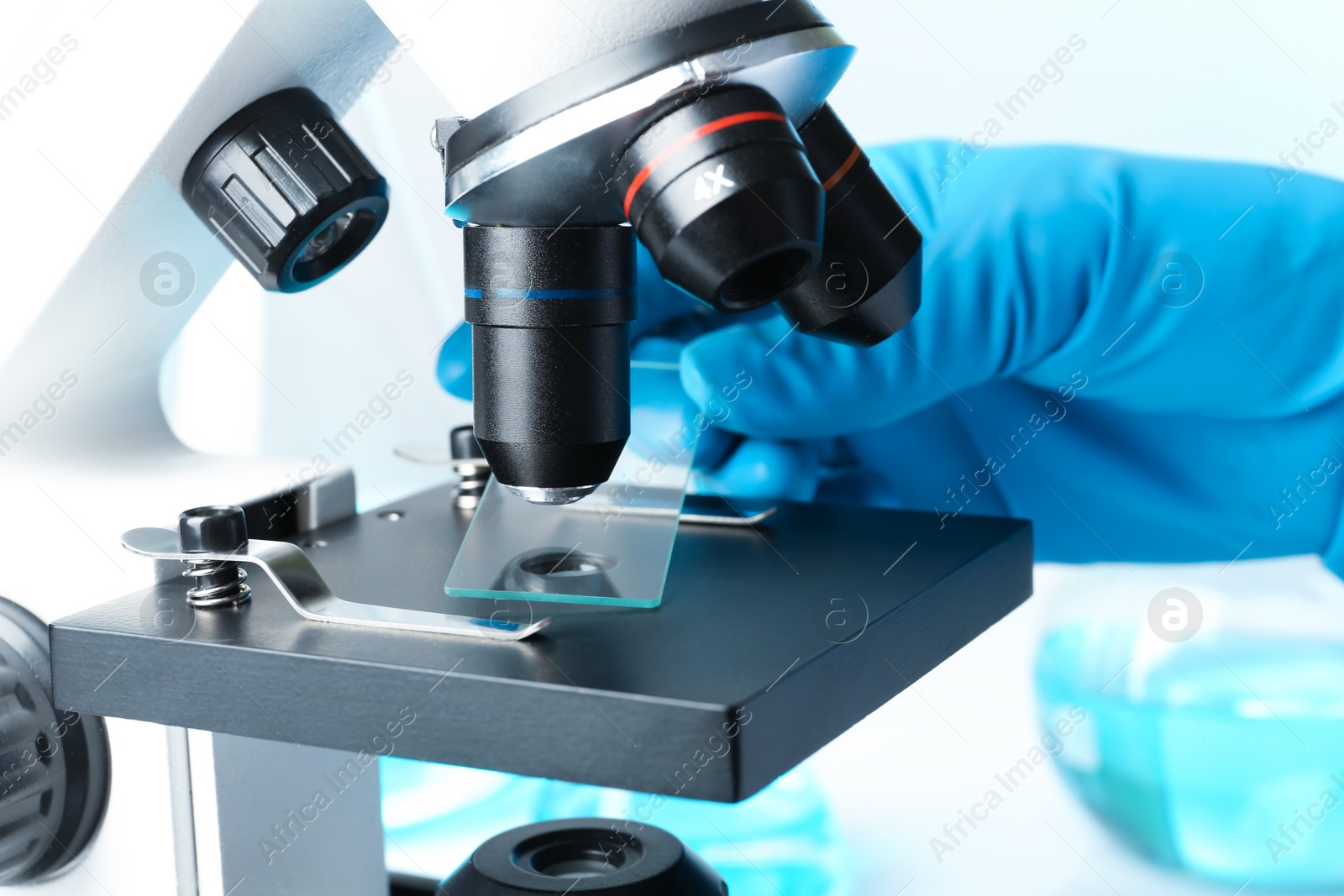 Photo of Scientist working with modern microscope, closeup. Chemical research