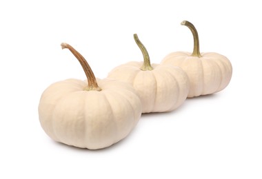 Three ripe beige pumpkins isolated on white