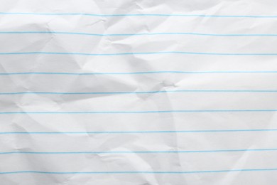 Photo of Crumpled lined notebook sheet as background, top view