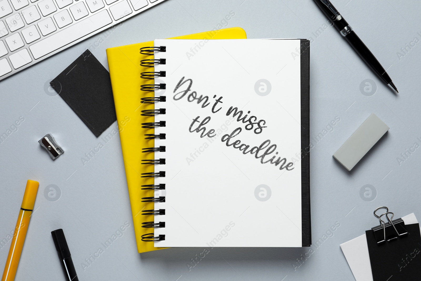 Image of Notebook with reminder Don't Miss The Deadline on office desk, top view