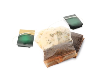 Photo of Used tea bags with tags on white background