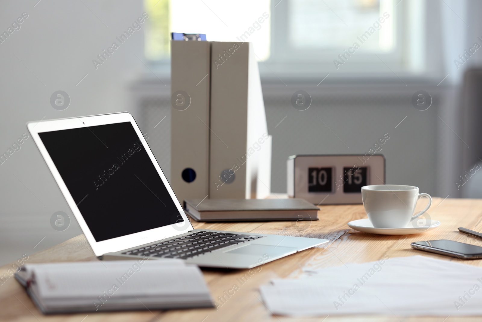 Photo of Modern laptop and supplies on table in office