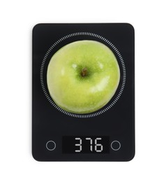 Photo of Ripe green apple and electronic scales on white background, top view