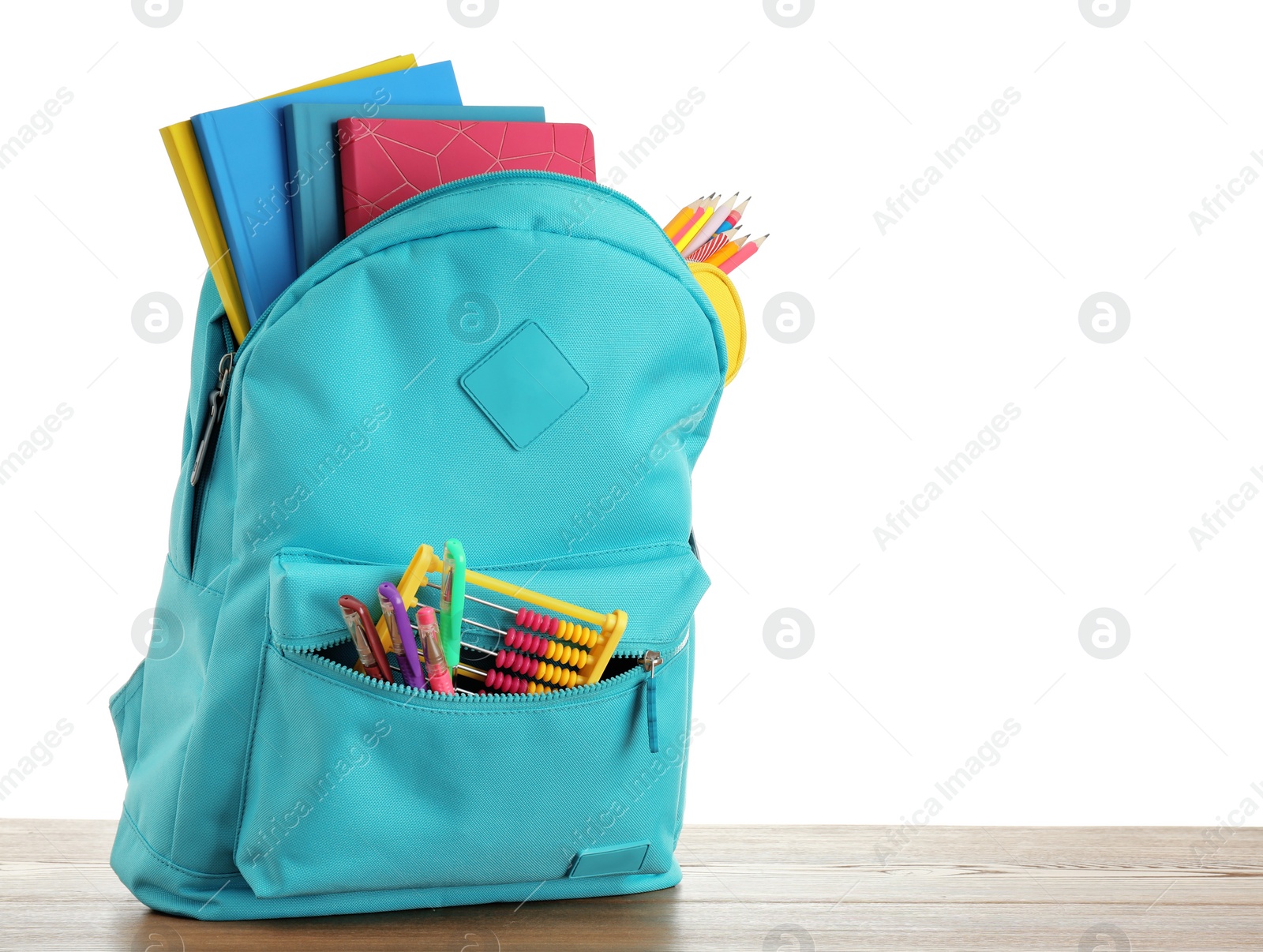 Photo of Bright backpack with school stationery on white background