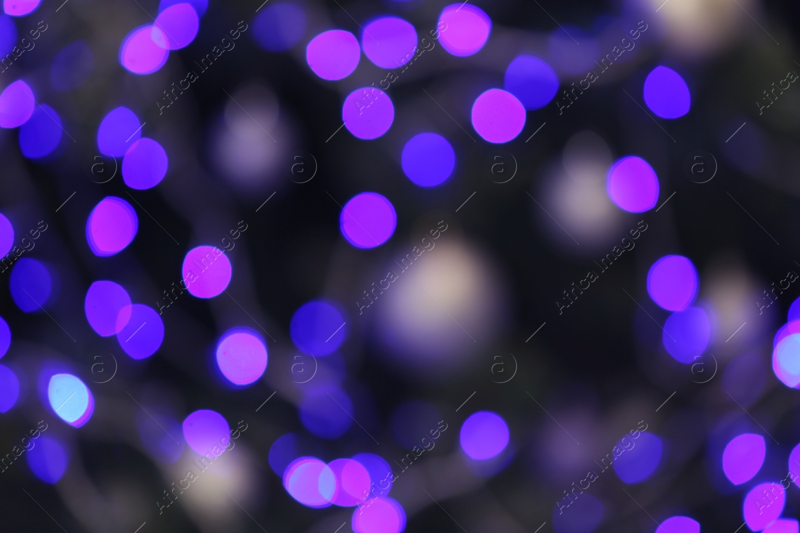 Photo of Blurred view of glowing Christmas lights as background. Festive mood