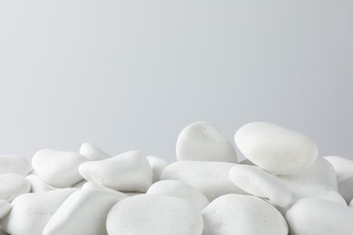 Photo of Presentation for product. White pebbles on light background. Space for text