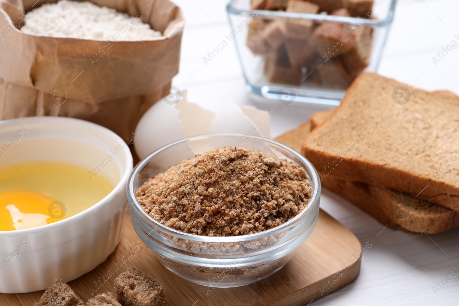 Photo of Fresh breadcrumbs, flour and egg on table