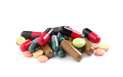 Photo of Pile of different colorful pills on white background