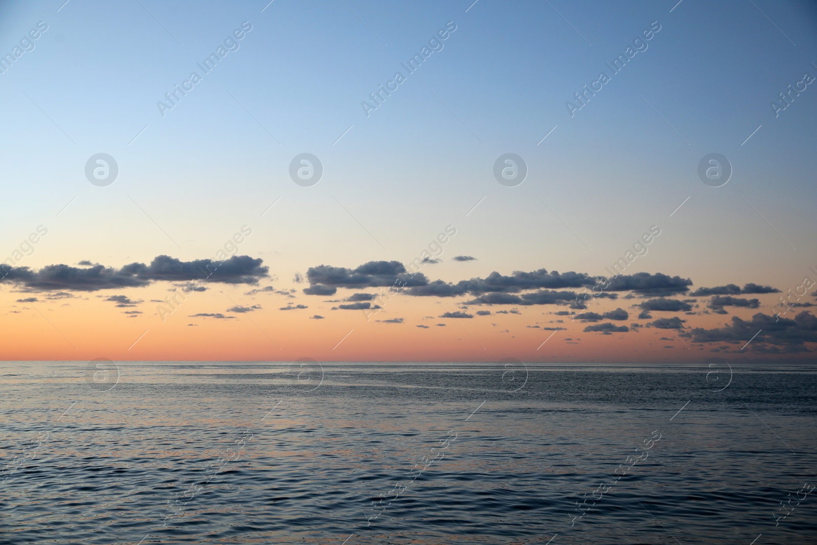 Photo of Picturesque view of sea under beautiful sky at sunset
