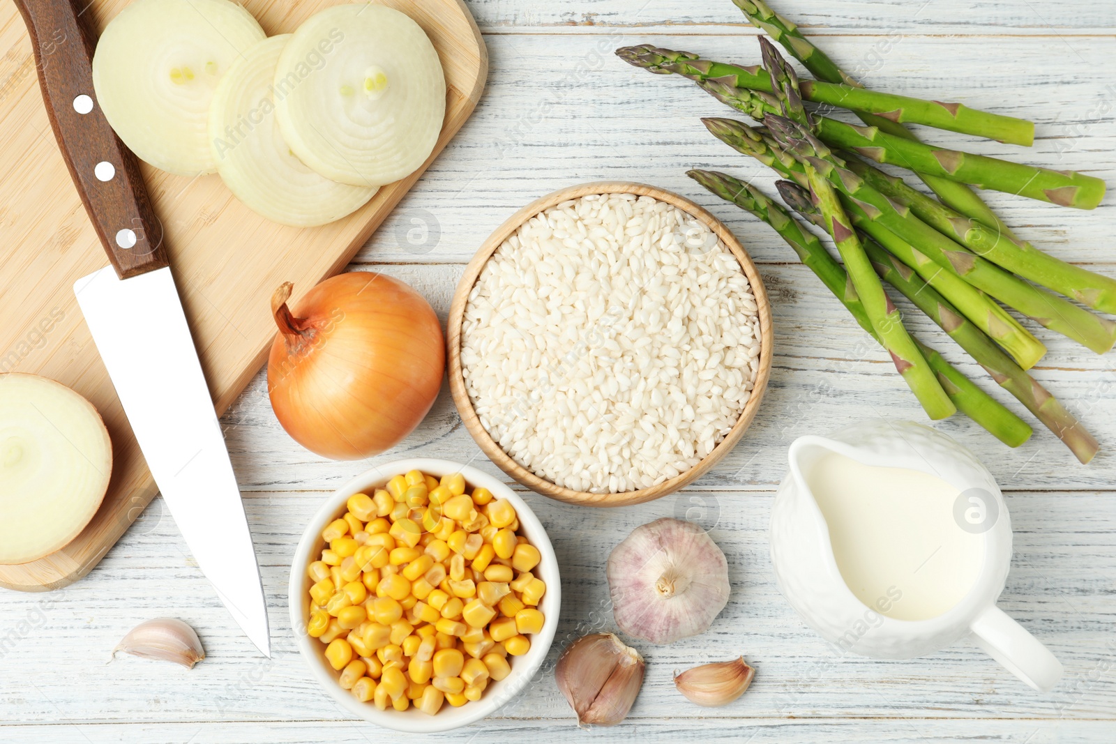 Photo of Flat lay composition with different ingredients on white wooden table. Risotto recipe