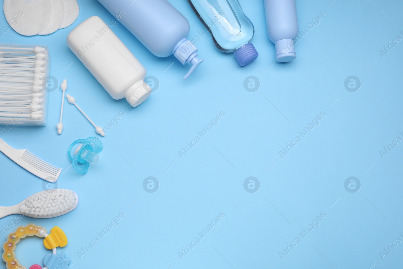 Photo of Flat lay composition with baby care products and accessories on light blue background, space for text