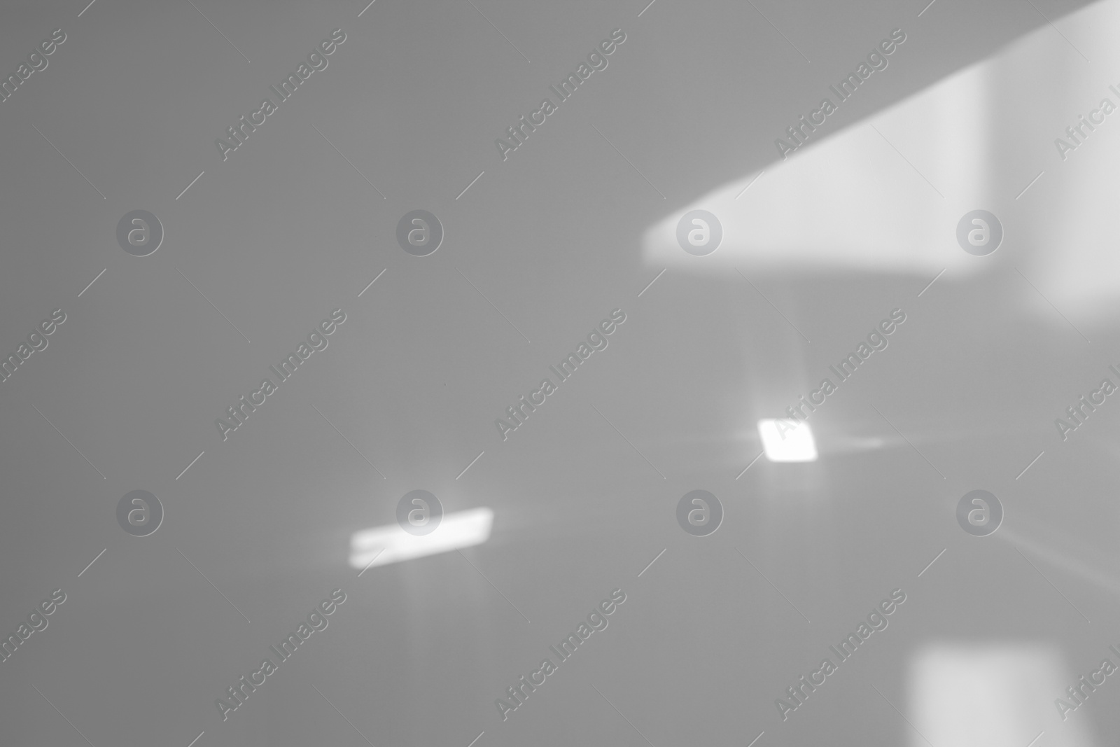 Photo of Light and shadow from window on beige wall indoors