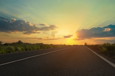 Image of View of empty asphalt road at sunset
