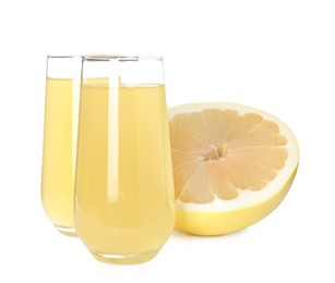 Photo of Glasses of fresh pomelo juice and fruit isolated on white