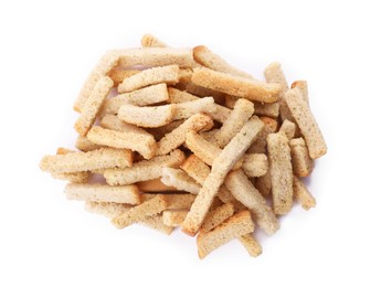 Photo of Heap of crispy rusks with seasoning on white background, top view