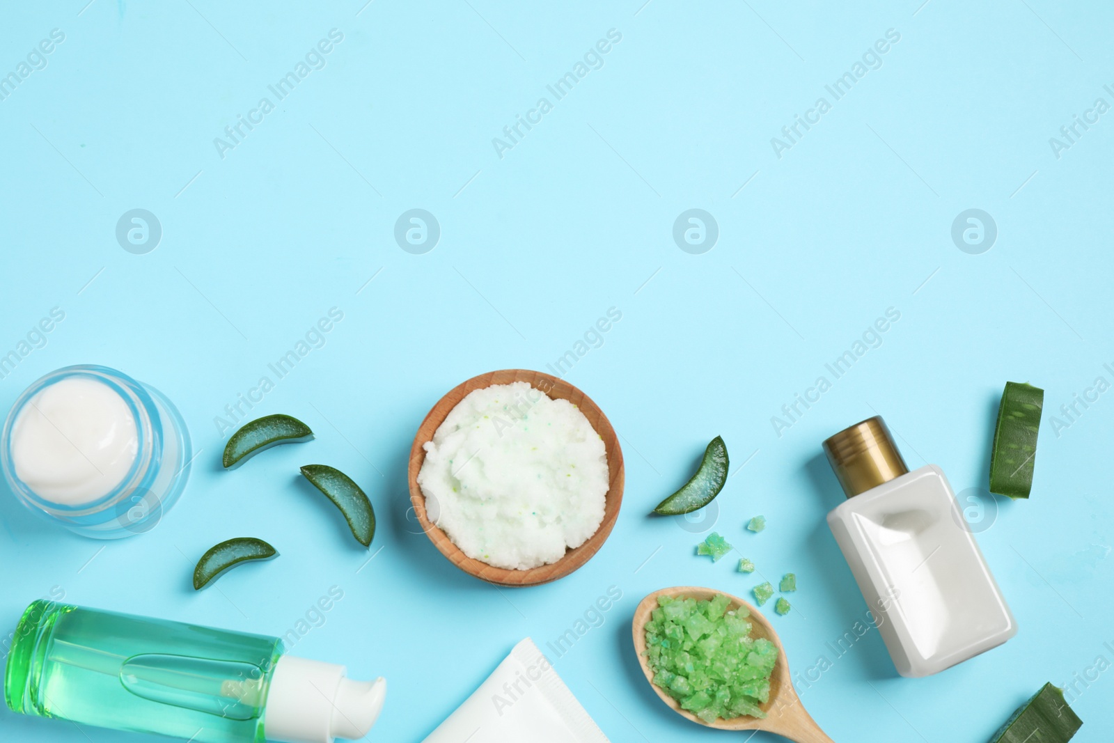 Photo of Flat lay composition with aloe vera and cosmetic products on light blue background. Space for text