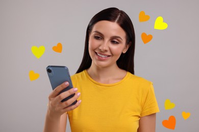 Image of Long distance love. Woman chatting with sweetheart via smartphone on grey background. Hearts flying out of device and swirling around her