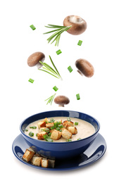 Image of Many different ingredients falling into bowl with homemade mushroom soup on white background