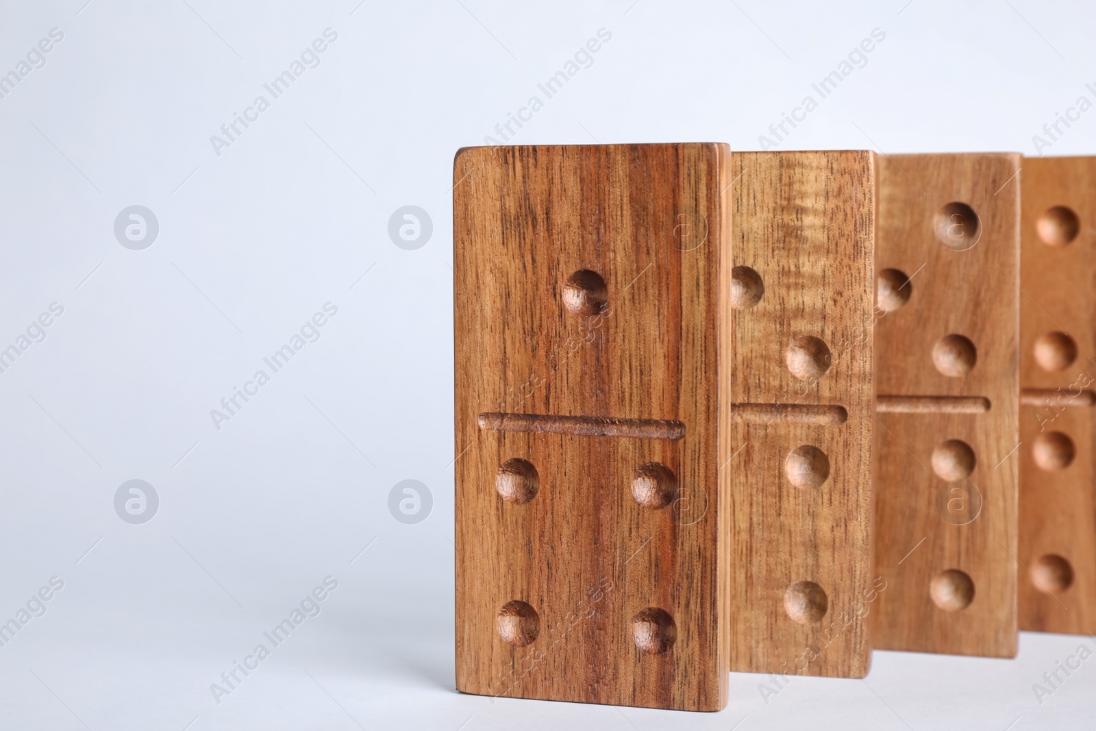 Photo of Set of wooden domino tiles on light grey background