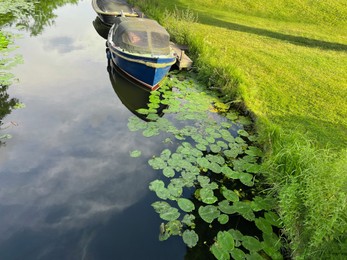 Photo of Beautiful view of moored boats in canal on sunny day