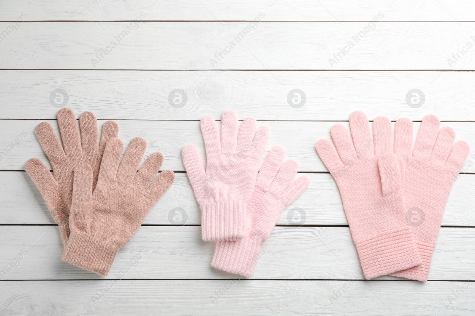 Photo of Stylish gloves on white wooden background, flat lay