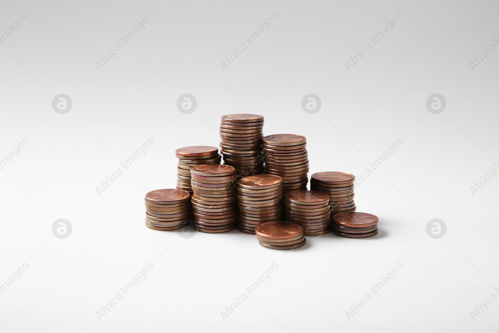 Photo of Many stacks of American coins on white background