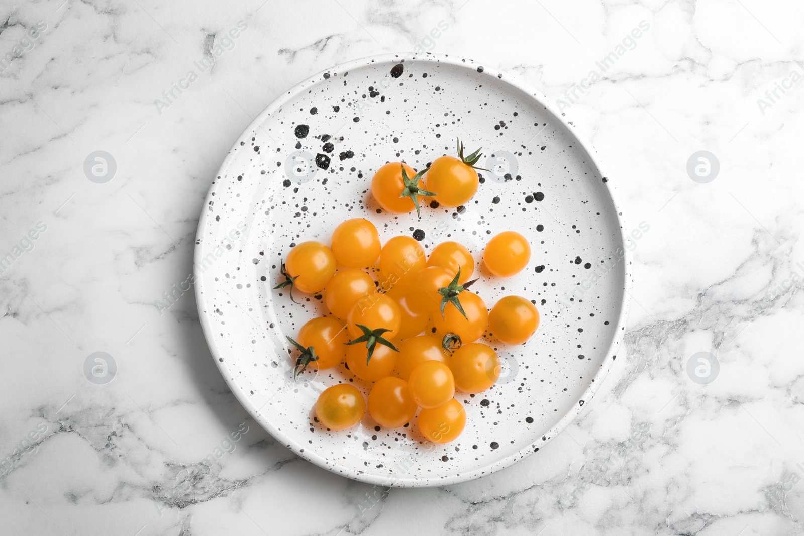 Photo of Ripe yellow tomatoes on white marble table, top view