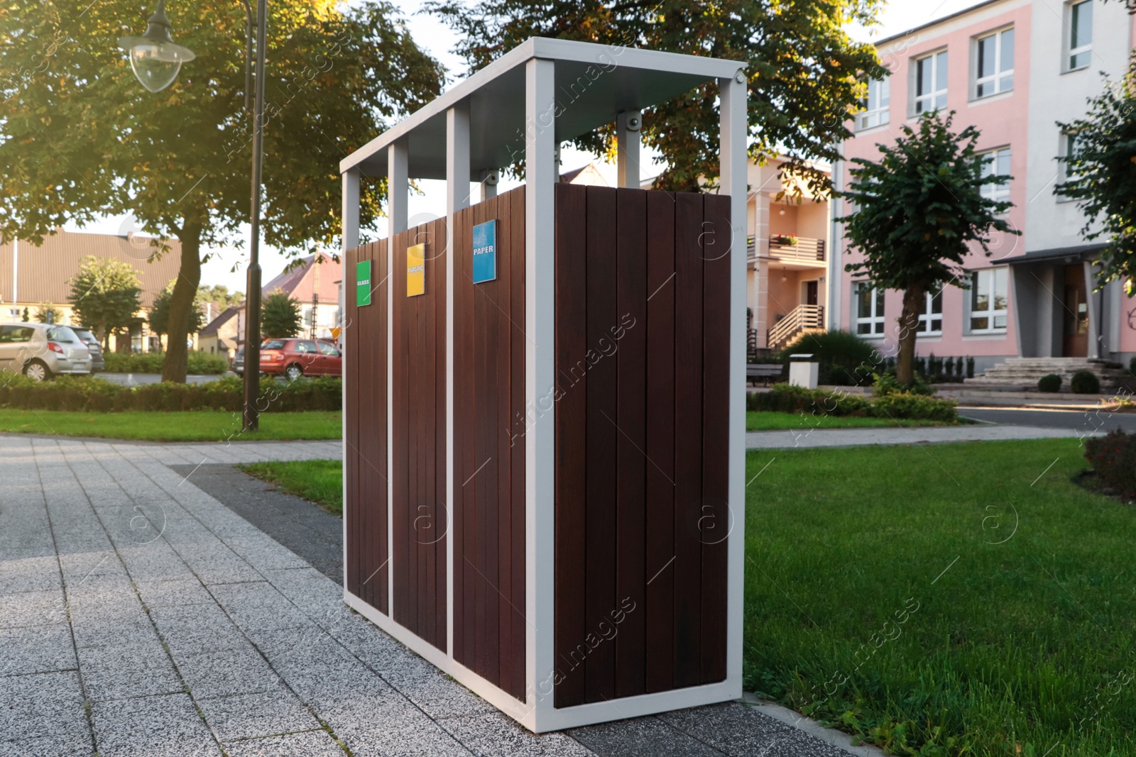 Photo of Different sorting bins for waste recycling outdoors