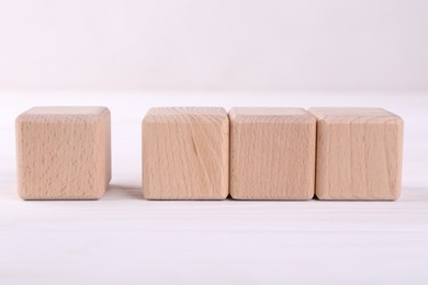 Photo of International Organization for Standardization. Wooden cubes with check mark and abbreviation ISO on white table