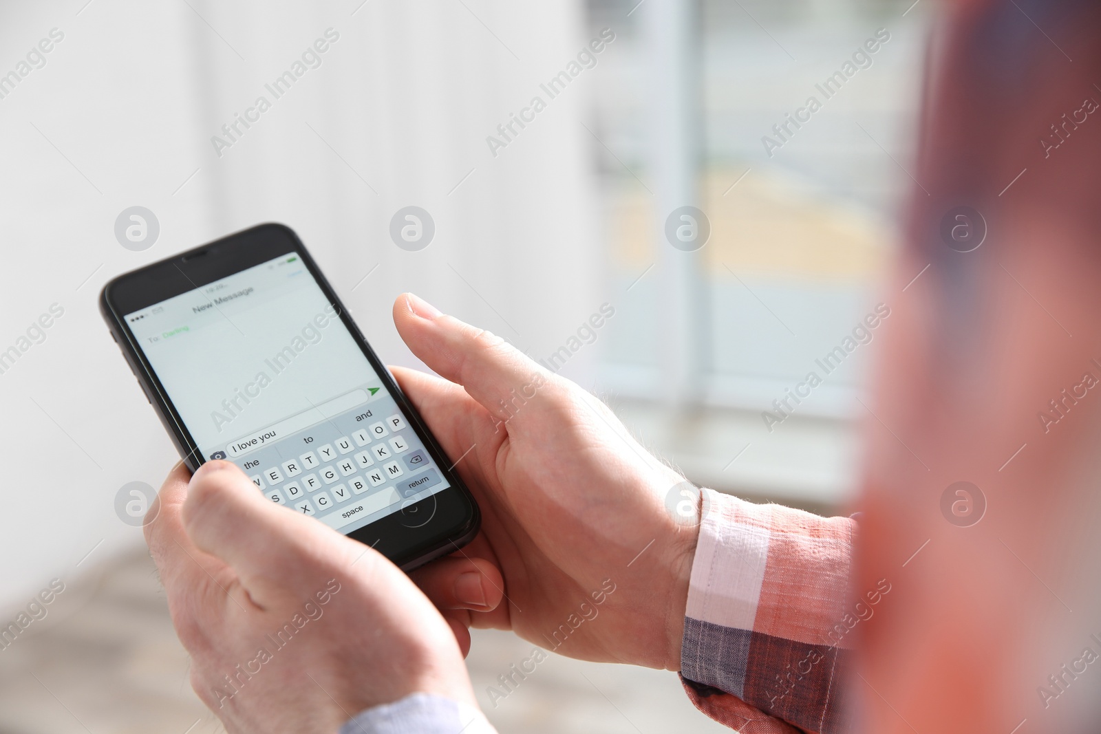 Photo of Man sending message with text I Love You indoors, closeup