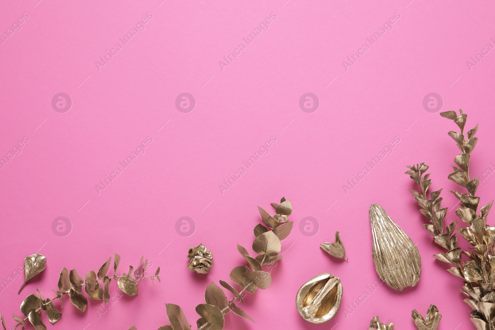 Photo of Flat lay composition with golden dried flowers and eucalyptus branches on pink background. Space for text