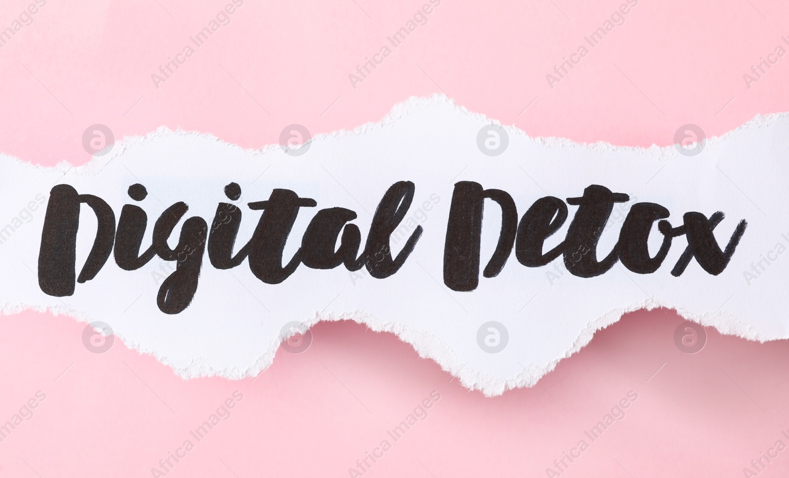 Photo of Paper note with phrase DIGITAL DETOX on pink background, top view