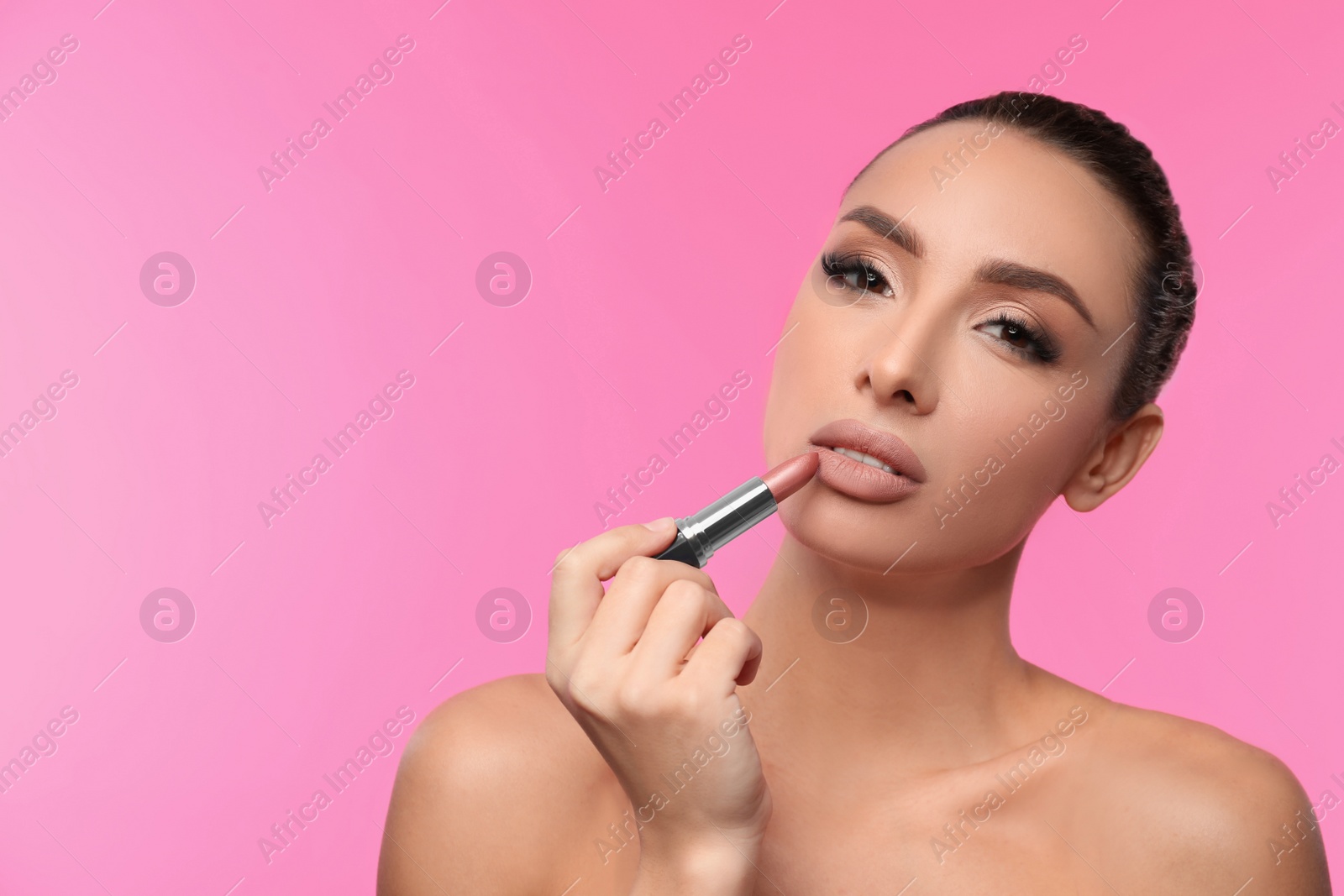 Photo of Beautiful woman with matte lipstick on pink background, space for text