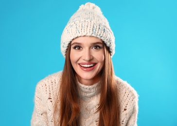 Photo of Young woman wearing Christmas sweater on blue background