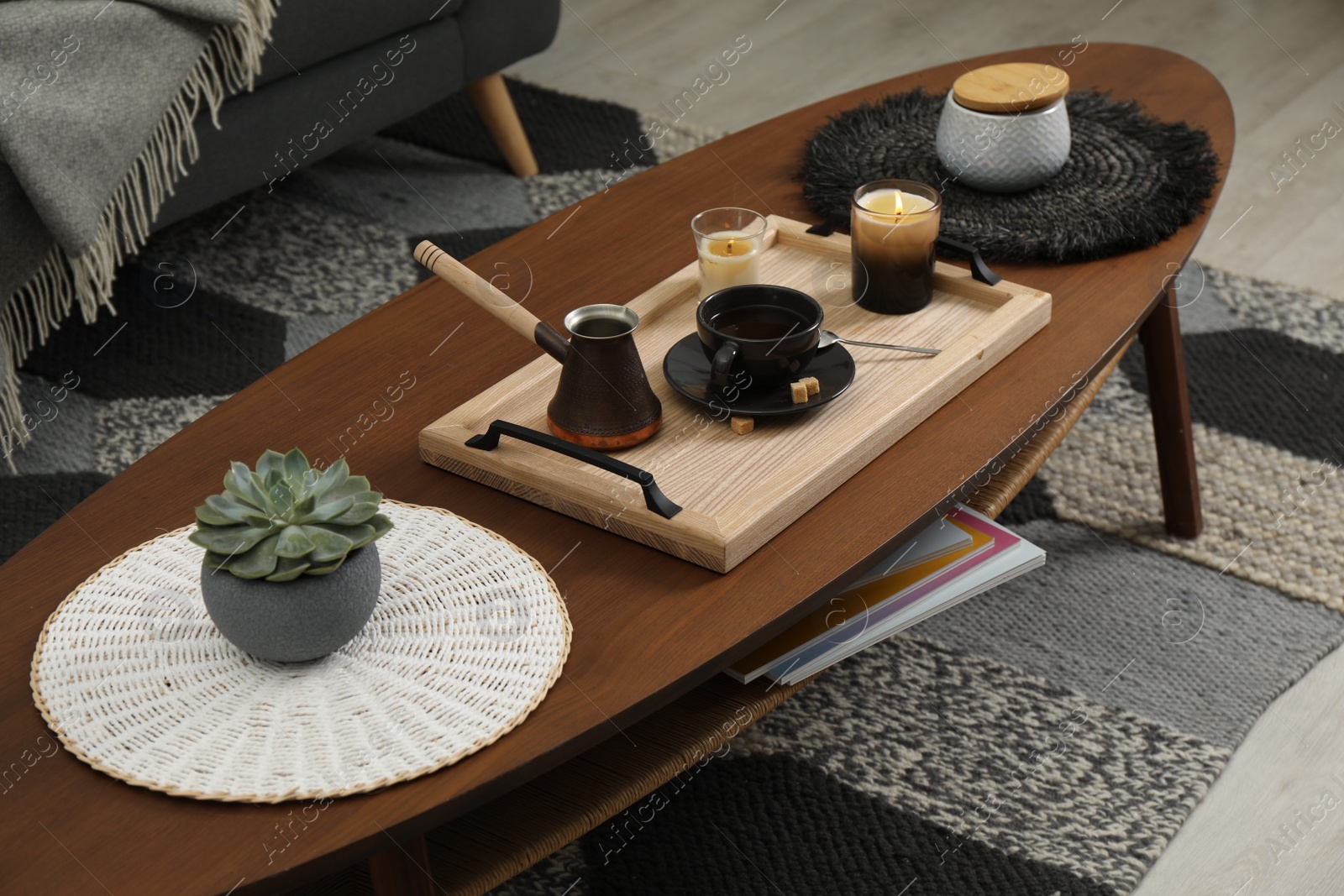 Photo of Tray with freshly made coffee and decorative elements on wooden table in room