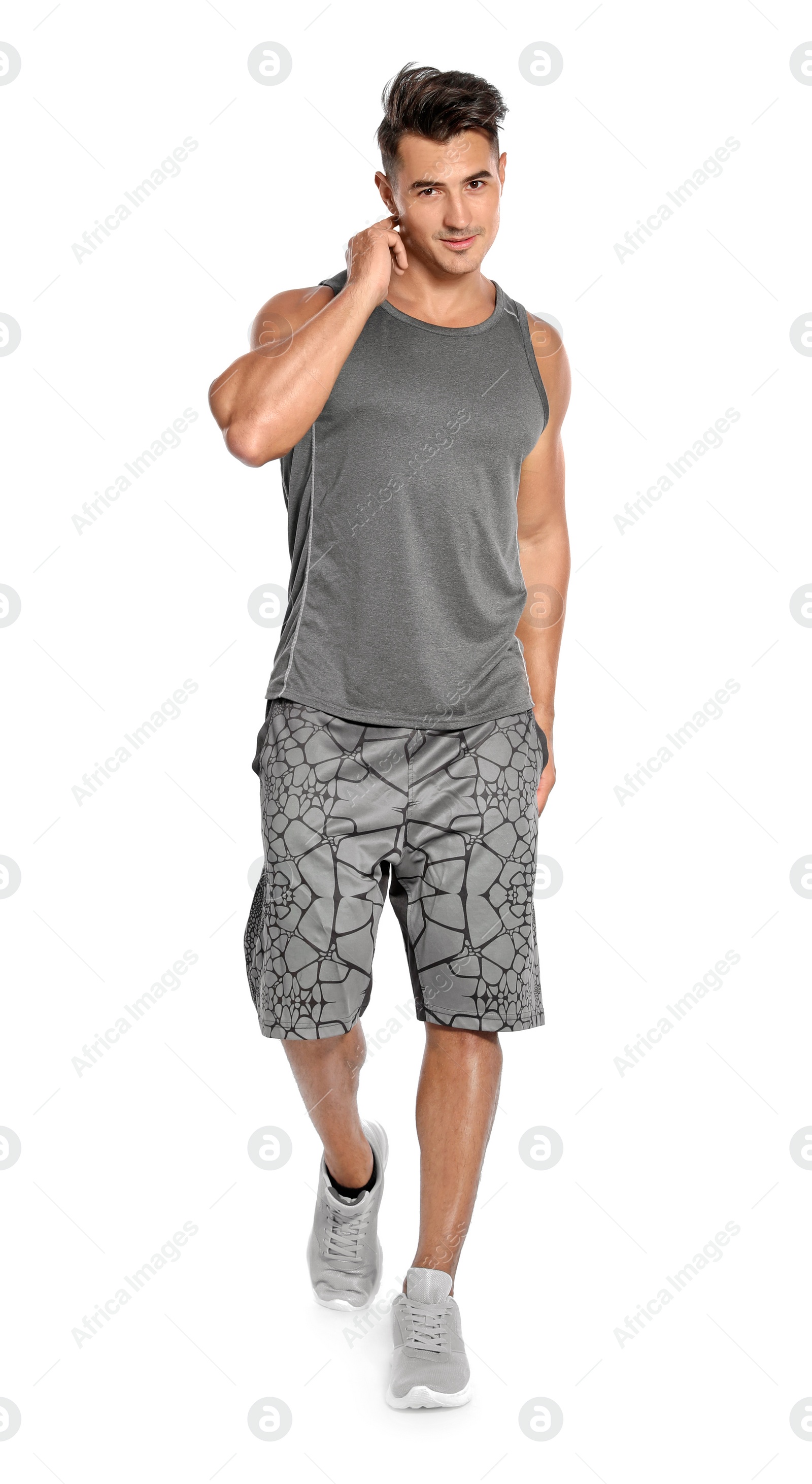 Photo of Handsome young runner posing on white background