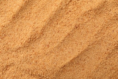 Photo of Brown coconut sugar as background, top view