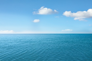 Image of Ripply sea under blue sky with clouds