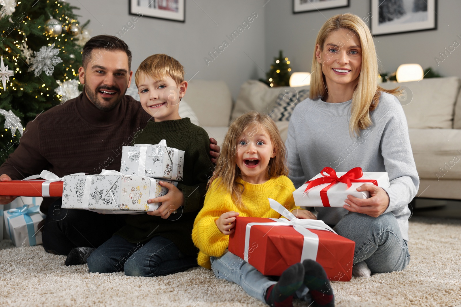 Photo of Happy family with Christmas gifts at home