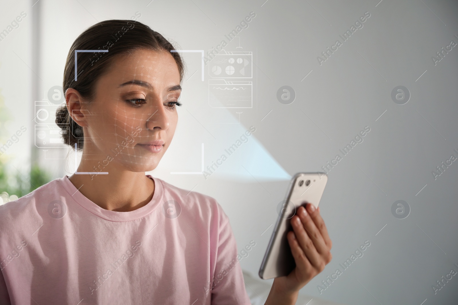 Image of Young woman unlocking smartphone with facial scanner indoors. Biometric verification