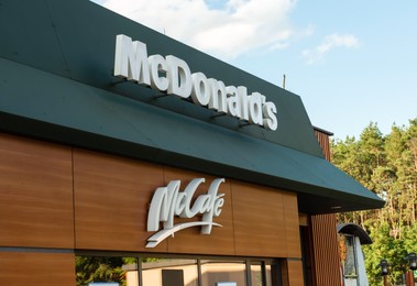 Photo of WARSAW, POLAND - SEPTEMBER 16, 2022: Signboard with McDonald's Restaurant and McCafe logo outdoors