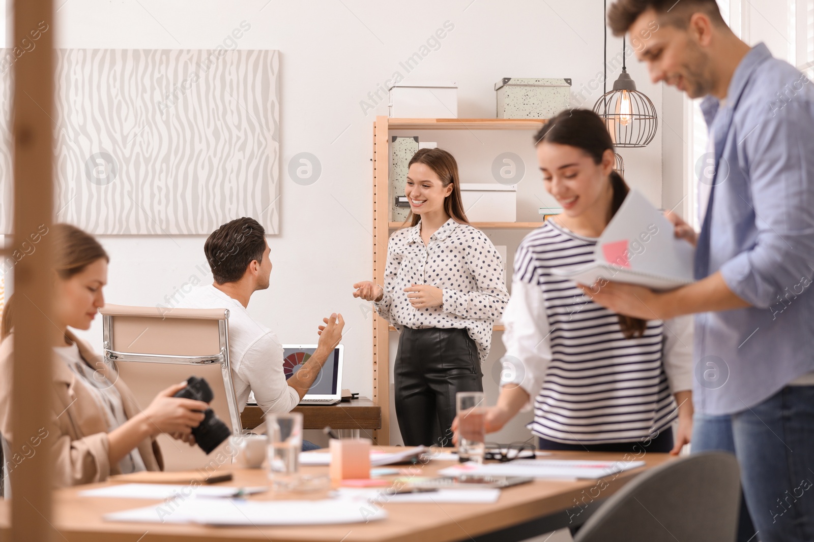 Photo of Team of professional journalists working in office