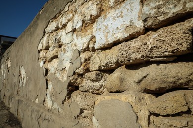 Photo of Stone building wall with cracks after strong earthquake