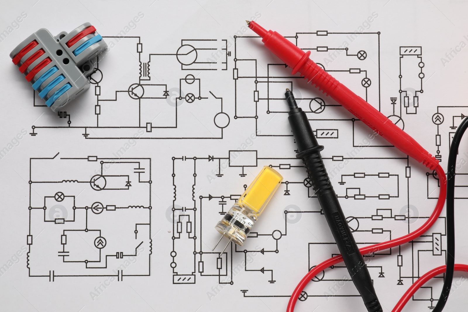 Photo of Different electrician's equipment on wiring diagram, flat lay