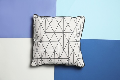 Soft decorative pillow on color background, top view