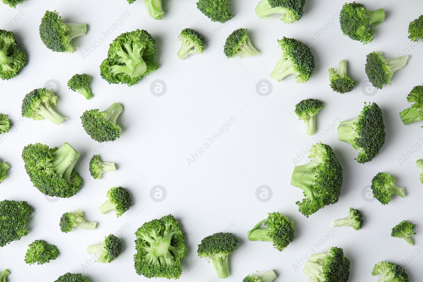 Photo of Frame made with fresh green broccoli on color background, top view. Space for text