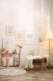 Photo of Stylish child's room interior with comfortable armchair and beautiful pictures