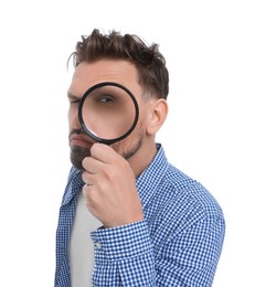 Handsome man looking through magnifier on white background