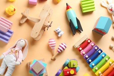 Photo of Different toys on beige background, flat lay